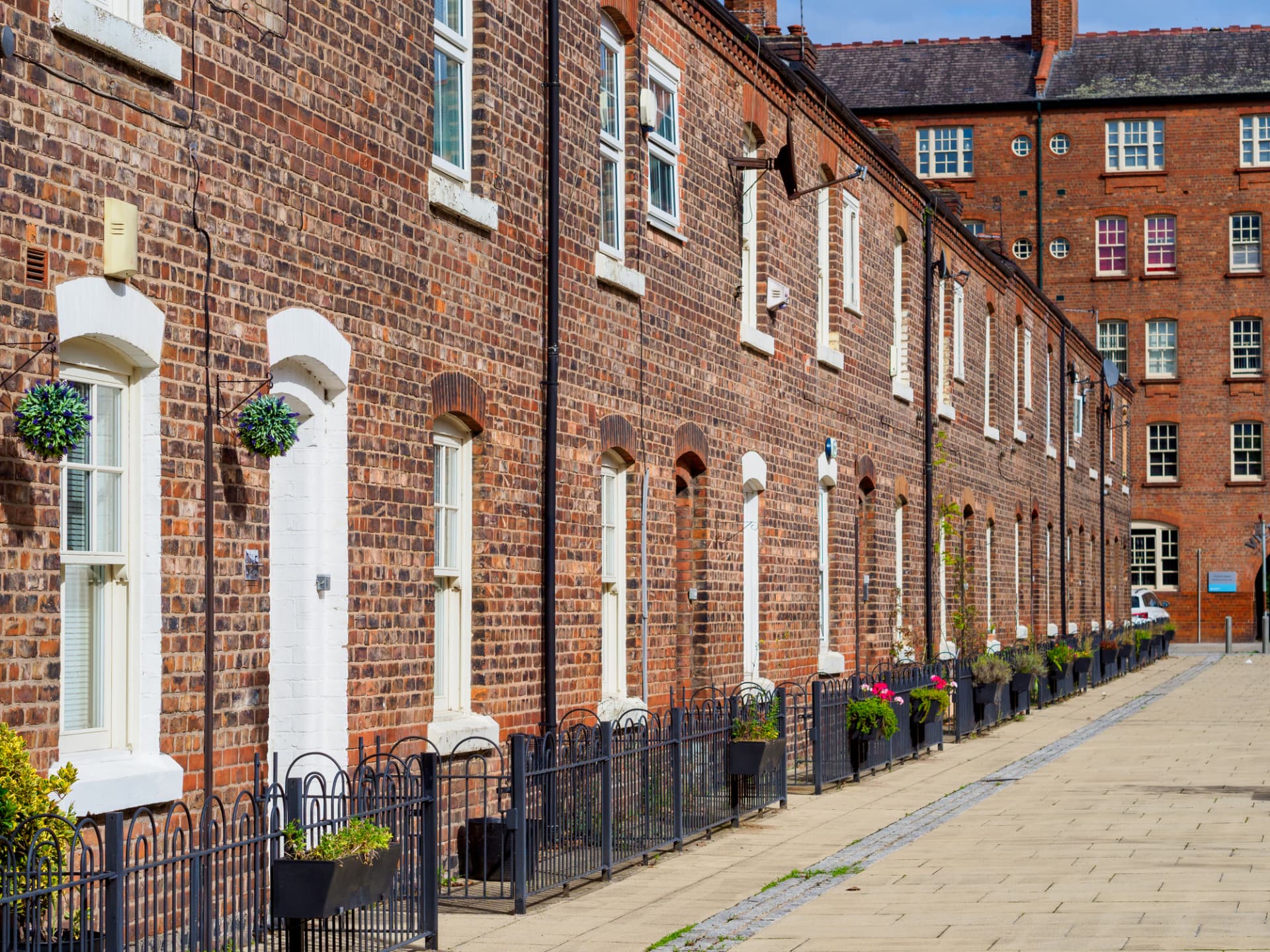 A row of red brick terraced houses in the North West of England